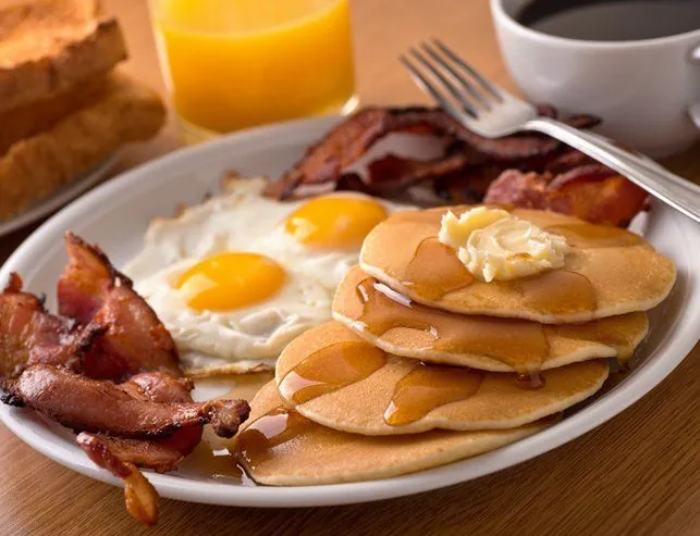 Pancakes, eggs and bacon breakfast plate